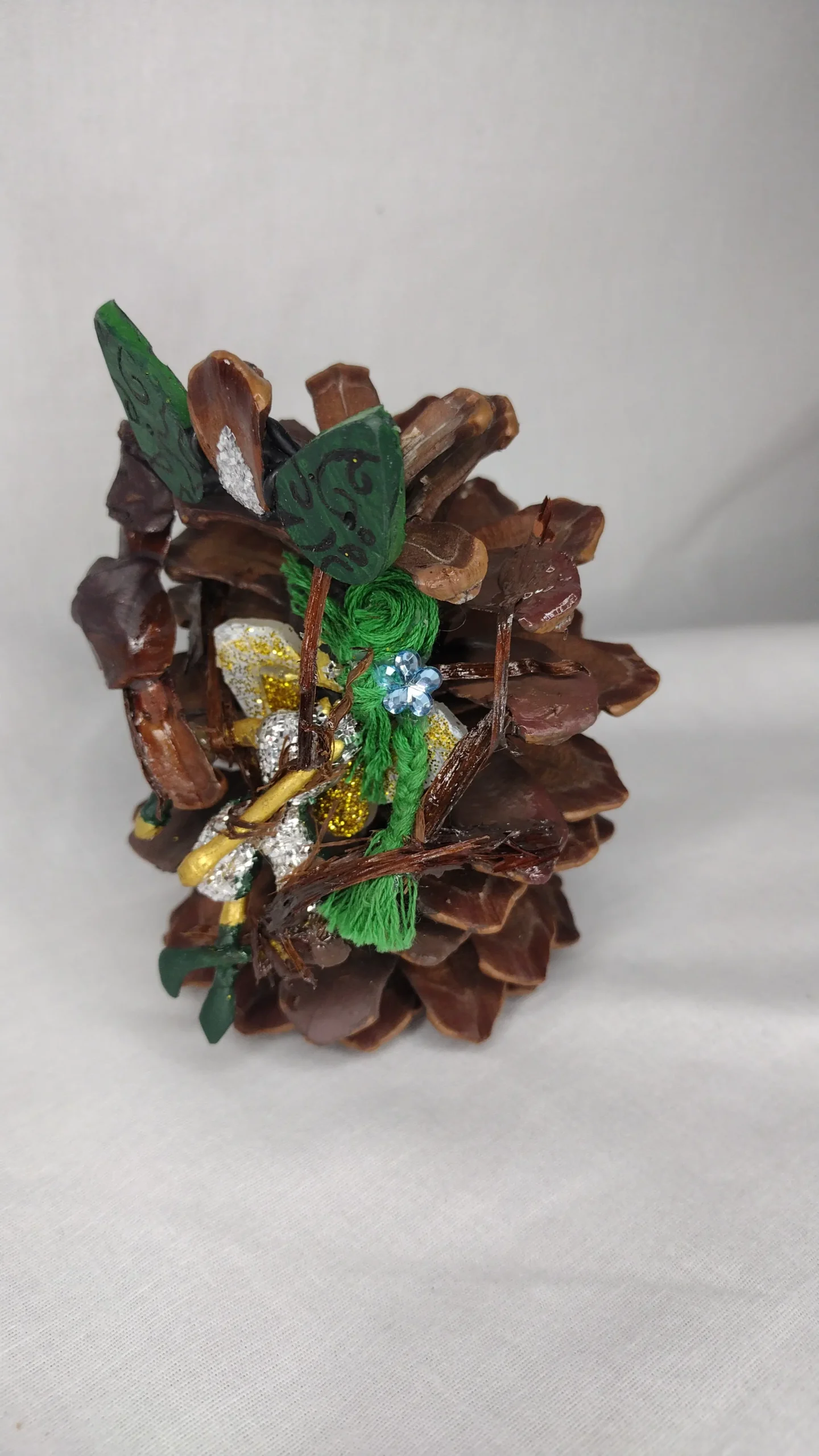 Tragic Irony painted and decorated pinecone